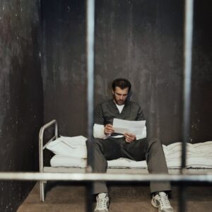 a man reading a letter inside his cell